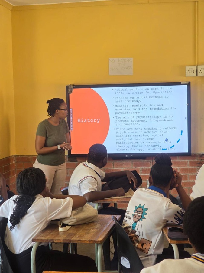 A volunteer presenter speaking to a classroom about a career in physiotherapy