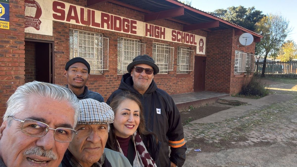 Foad Naimi and members of the Mona With The Children team outside Saulridge Secondary School